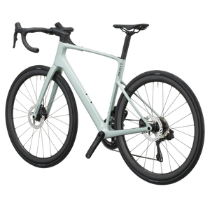 Sand green Scott Addict 30 road bike from a rear three-quarter angle showing the dropped seat stays and disc rotors.