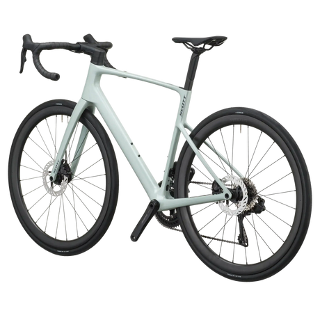 Sand green Scott Addict 30 road bike from a rear three-quarter angle showing the dropped seat stays and disc rotors.