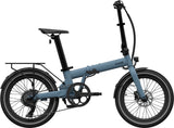 Ocean blue folding electric bike with compact frame, rear rack, and mid-sized tires.