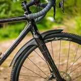 Mudhugger Gravel Hugger front mudguard fitted inside the fork of a gravel bike on a gravel track