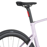 Violet pink Scott Fastlane 20 electric road bike close-up on rear frame and saddle with black tire and tube seatpost.