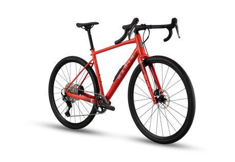 A red gravel bicycle with black components, drop handlebars, and a black saddle, shown from a three-quarters angle on a white background with a soft shadow.