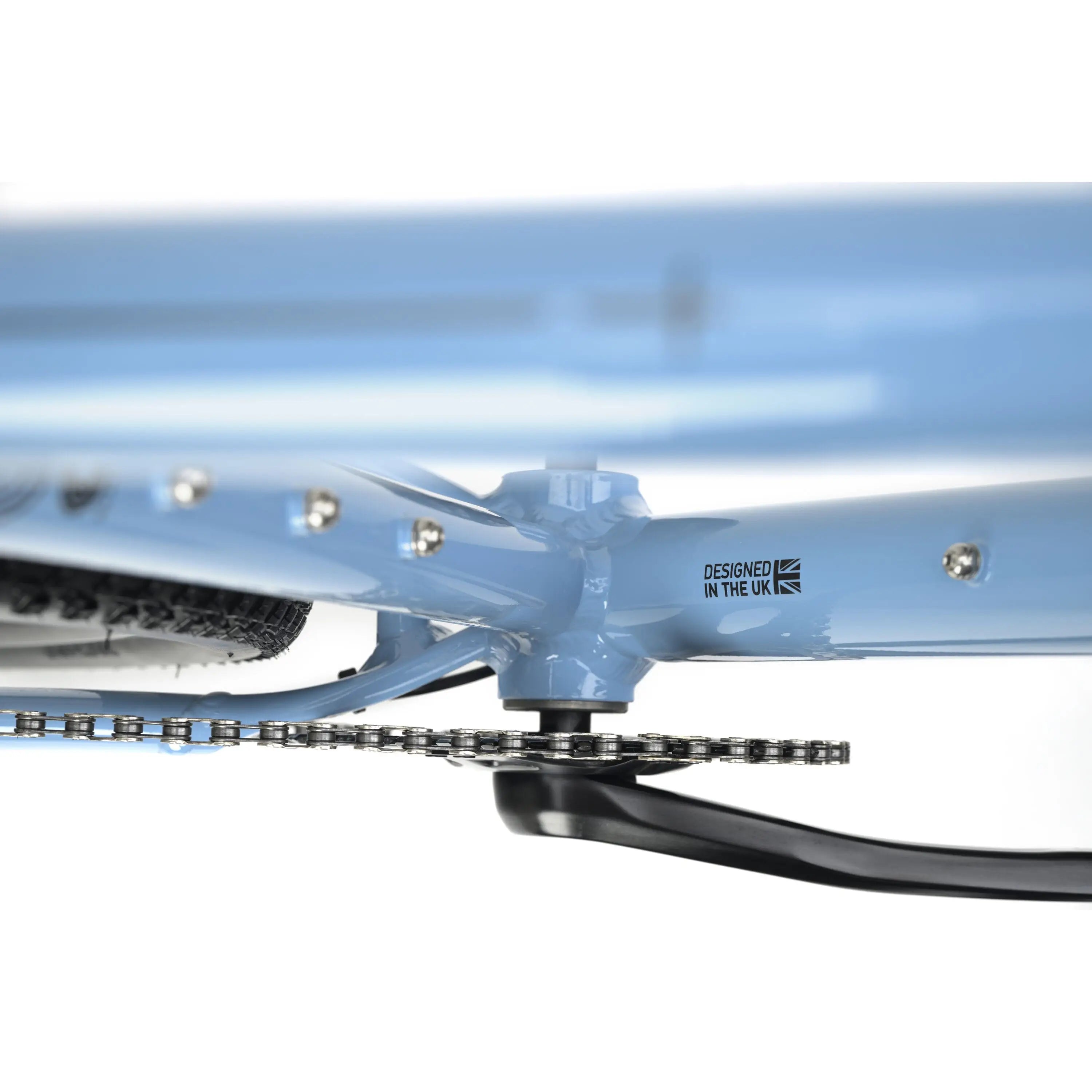 Light blue Genesis CDA 10 gravel bike bottom bracket area with Shimano crankset and chain visible.