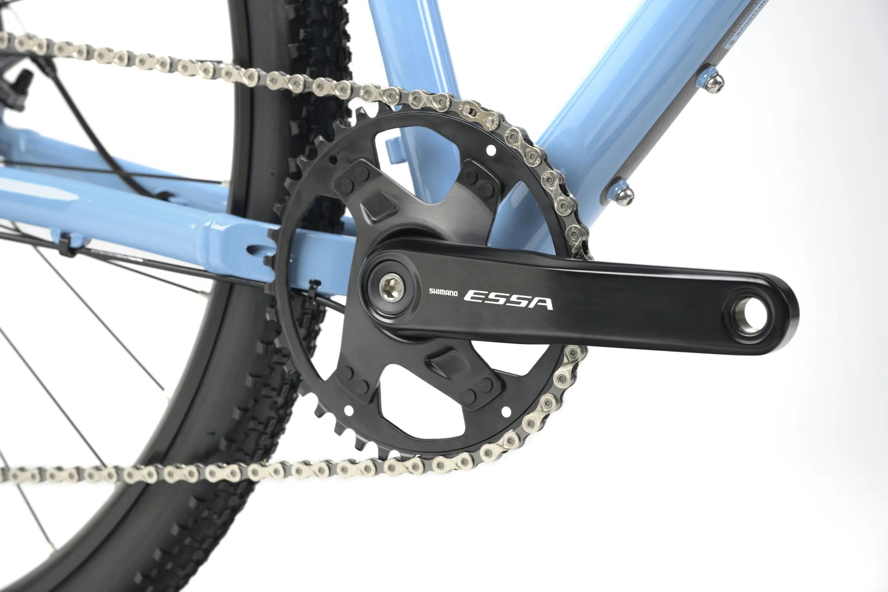 Black crankset with ESSA branding on a light blue Genesis CDA 10 Gravel Bike frame with knobby tires.