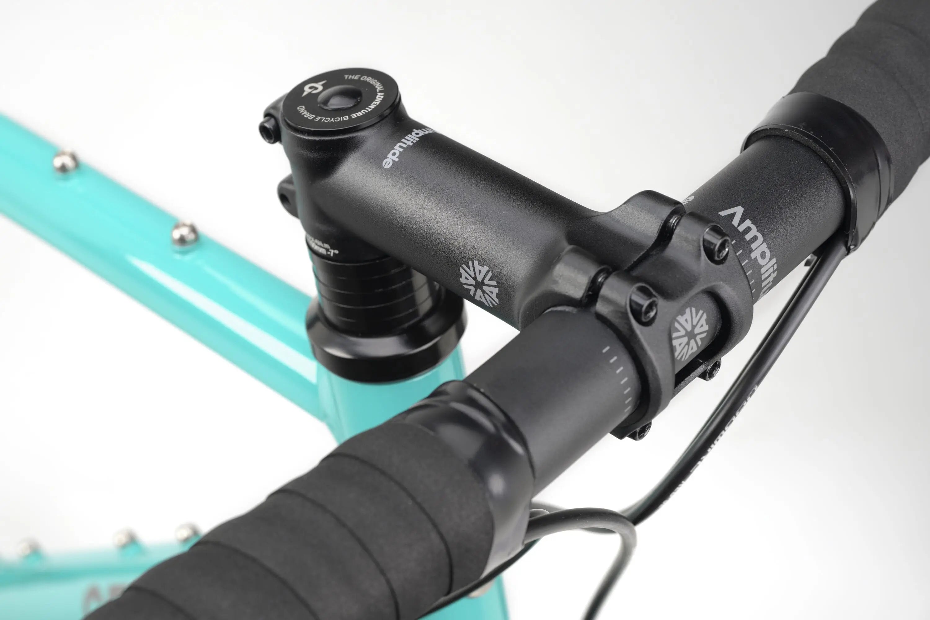 Close-up of John Teal Genesis CDA 20 gravel bike handlebar with black tape and stem detail.
