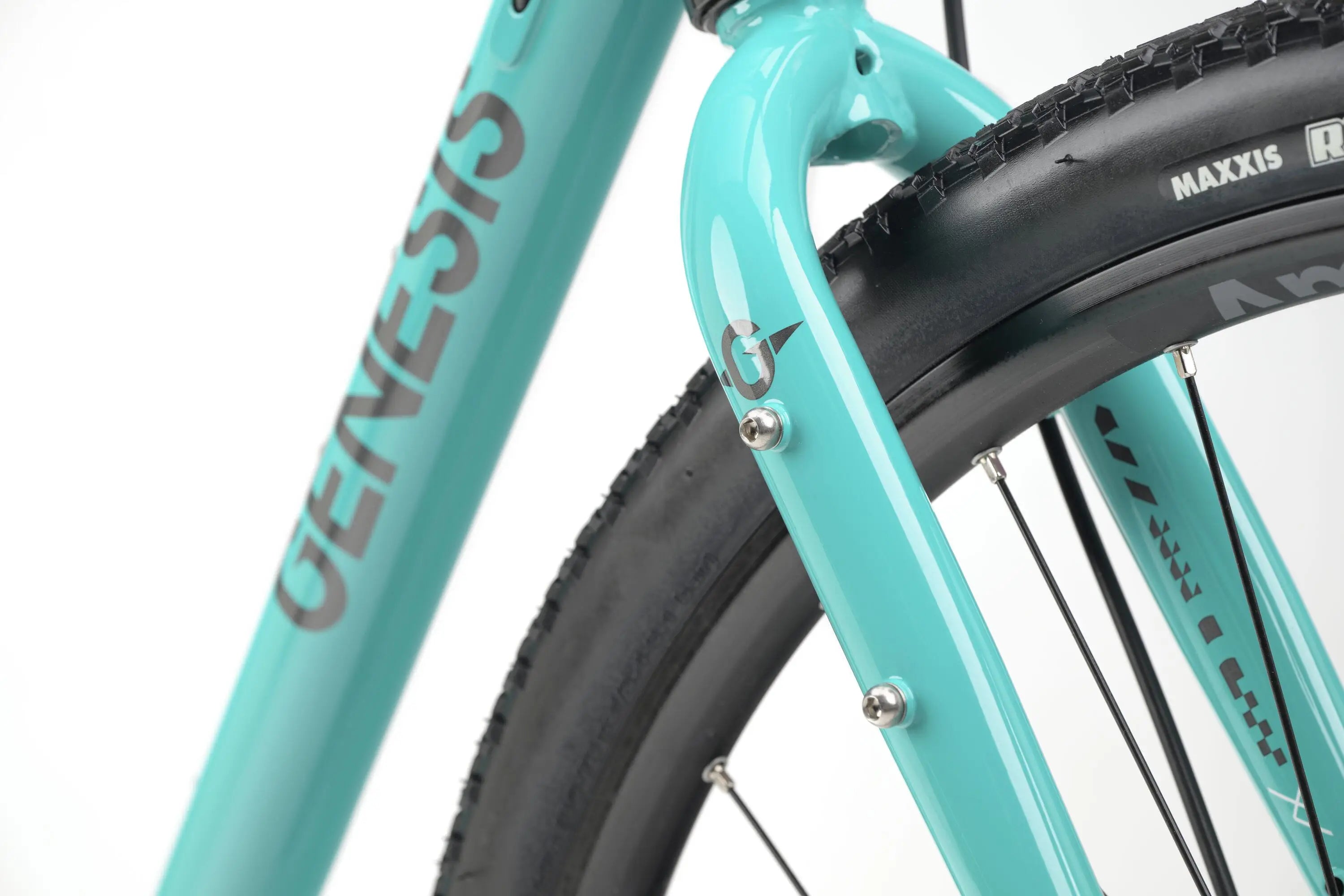 Close-up of teal Genesis CDA 20 gravel bike frame and front fork with black Maxxis tire.