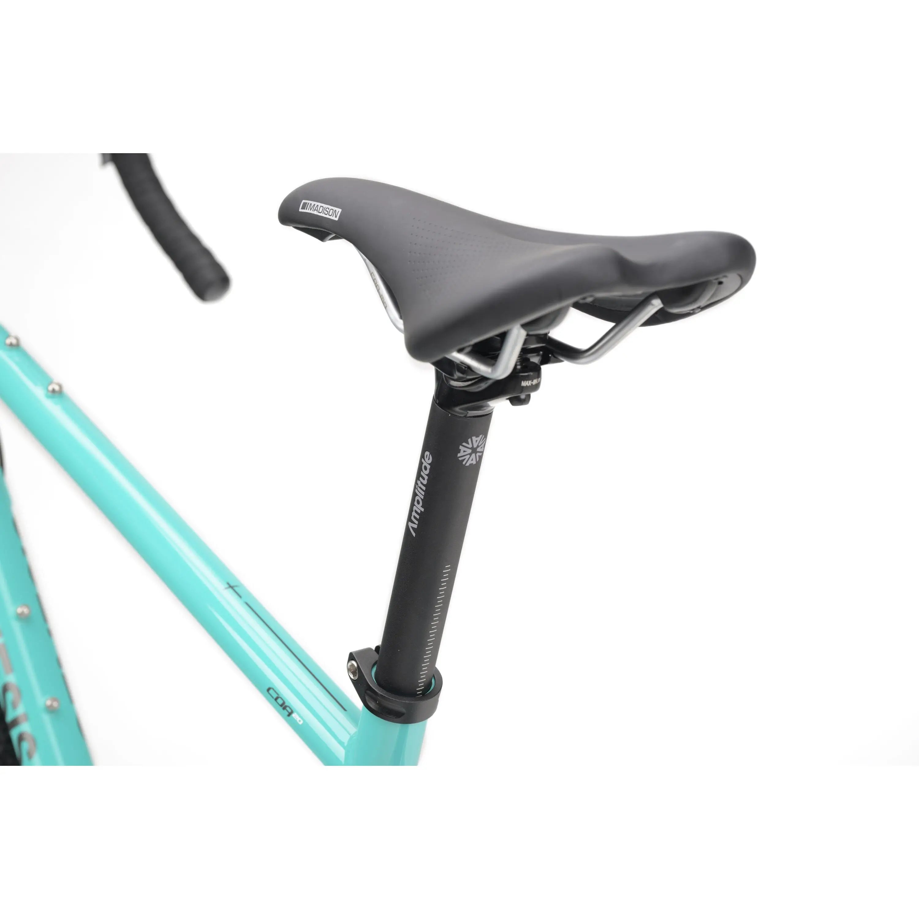 Black ergonomic saddle and seat post mounted on teal-colored gravel bike frame.
