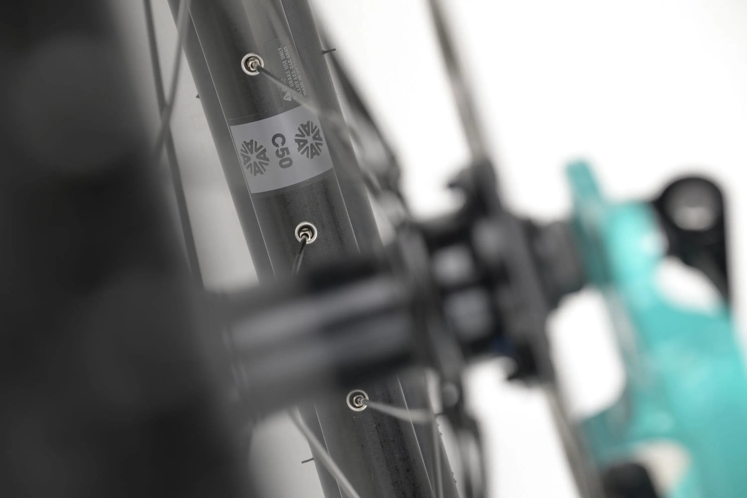Close-up of a teal Genesis CDA 20 gravel bike frame showing brake mounts and textured detailing.