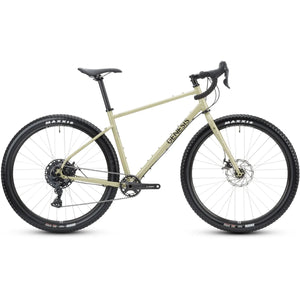 Genesis Vagabond 10 Gravel Bike in beige with drop handlebars and Maxxis tires, designed for off-road and adventure cycling.