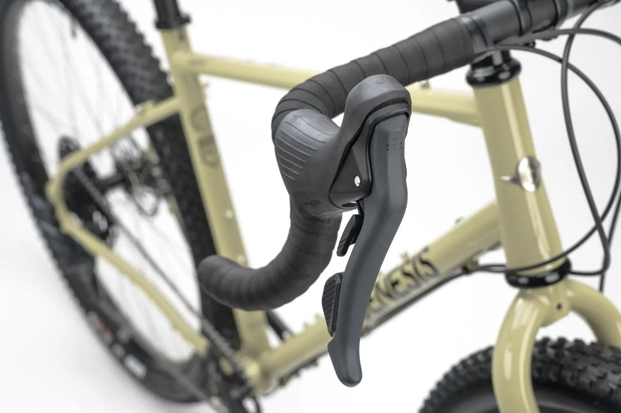 Close-up of the Genesis Vagabond 10 Gravel Bike's ergonomic drop handlebar with integrated brake and gear shifter for smooth control.