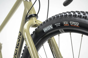 Maxxis Ikon tire on the Genesis Vagabond 10 Gravel Bike, featuring a tubeless-ready design for enhanced grip and durability on rough terrain.