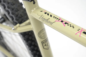 Top tube of the Genesis Vagabond 10 Gravel Bike with stylish graphics and branding, emphasizing its adventure-ready design.