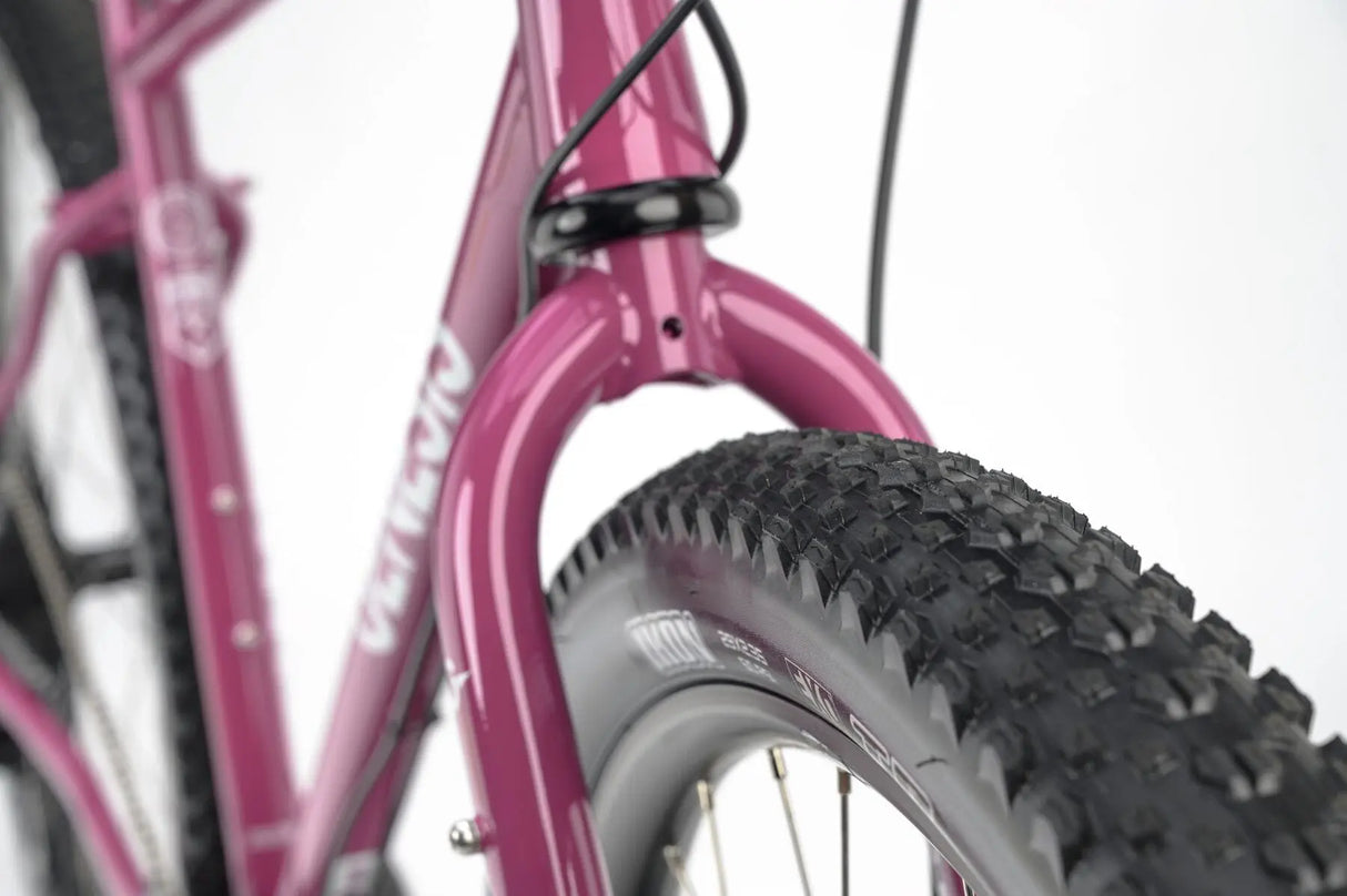 Front tire and fork of the Genesis Vagabond 20 Gravel Bike, designed for stability and control on mixed terrain.