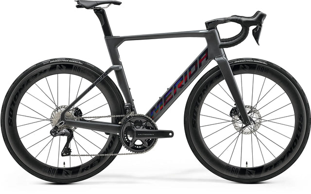 Merida Reacto 9000 Road Bike with aerodynamic carbon frame, deep-section Reynolds wheels, and Shimano Dura-Ace groupset for high-performance racing.