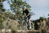Rider on a Merida Mission 7000 gravel bike picking a line across rocky ground