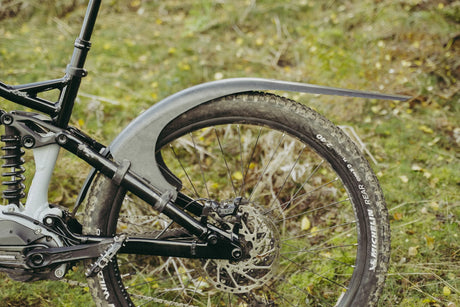 Mudhugger MK2 rear mudguard fitted to the seat stays of a full suspension mountain bike outdoors