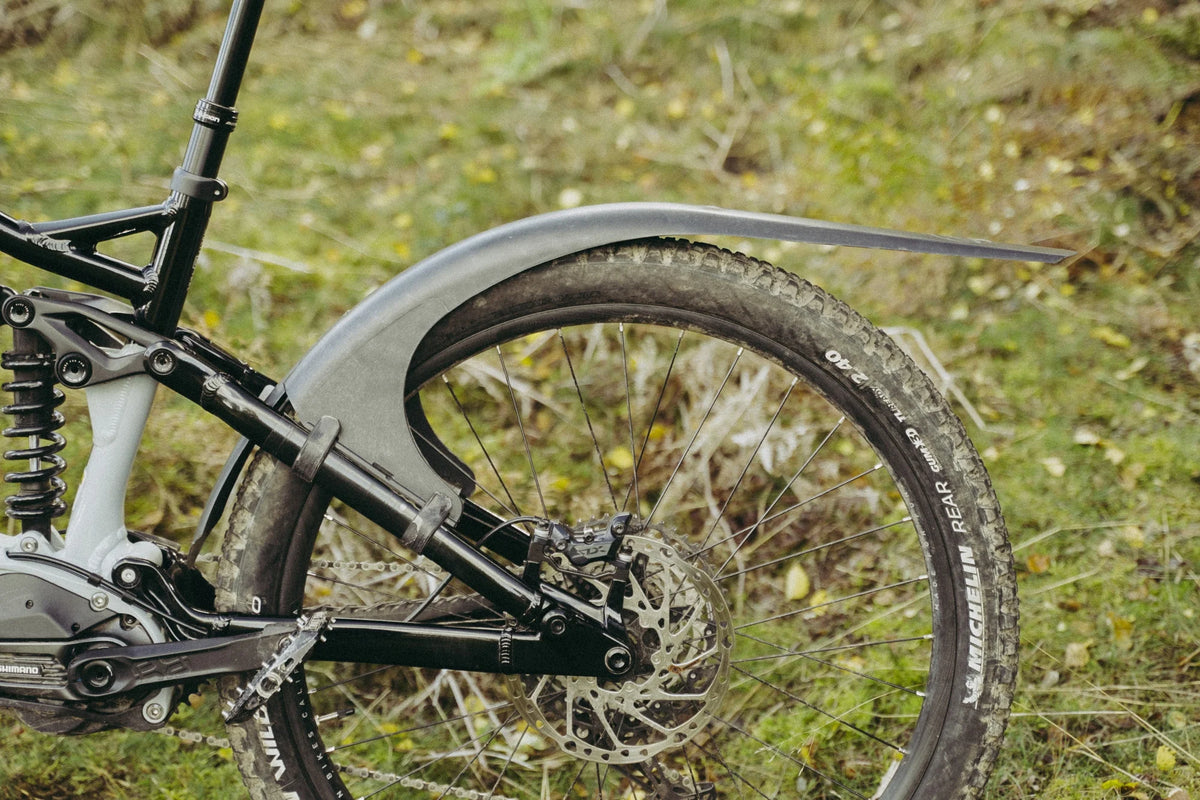 Mudhugger MK2 rear mudguard fitted to the seat stays of a full suspension mountain bike outdoors