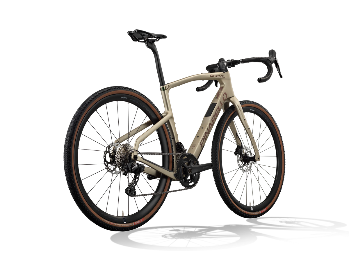 Altai Dust Pinarello Grevil F1 gravel bike from a rear three-quarter angle showing the rear derailleur and cassette.