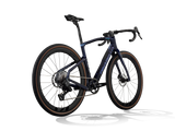 Lapland Sky Pinarello Grevil F5 gravel bike from a rear three-quarter angle showing the rear derailleur and cassette.