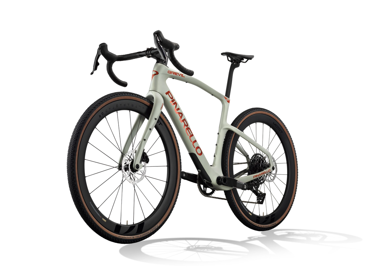Moab Amber Pinarello Grevil F7 gravel bike from a front three-quarter angle, non-drive side.