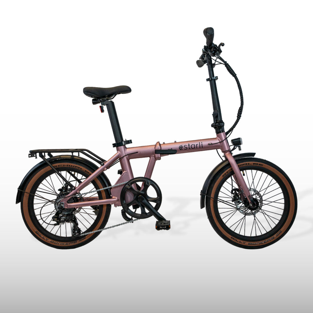 estarli E20.7 Comfort Hybrid E-Bike in rose gold with folding frame and brown tires, perfect for fashionable and functional commuting.