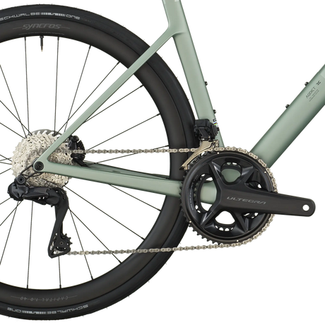 Close-up of a bicycle chain and gear system on a white background