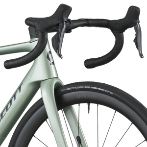 Close-up of a bicycle handlebar and front wheel on a white background