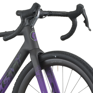 Close-up of a bicycle with a black and purple frame on a white background