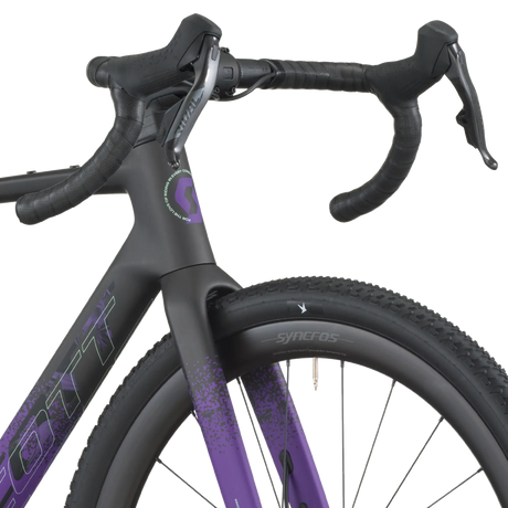 Close-up of a bicycle with a black and purple frame on a white background