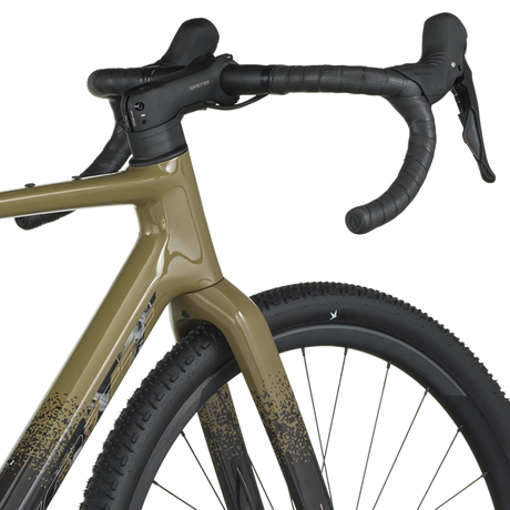 Close-up of a bicycle with a beige frame and black components on a white background