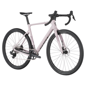 Side angle of Scott Addict Gravel 30 in light pink, featuring wide tires and carbon frame for optimal control on rugged gravel trails.
