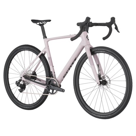 Side angle of Scott Addict Gravel 30 in light pink, featuring wide tires and carbon frame for optimal control on rugged gravel trails.