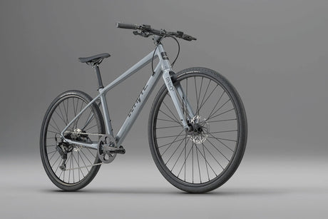 Whyte RHeO 0 hybrid bike in dark silver from a front three-quarter angle, showing the flat bar and front disc brake.