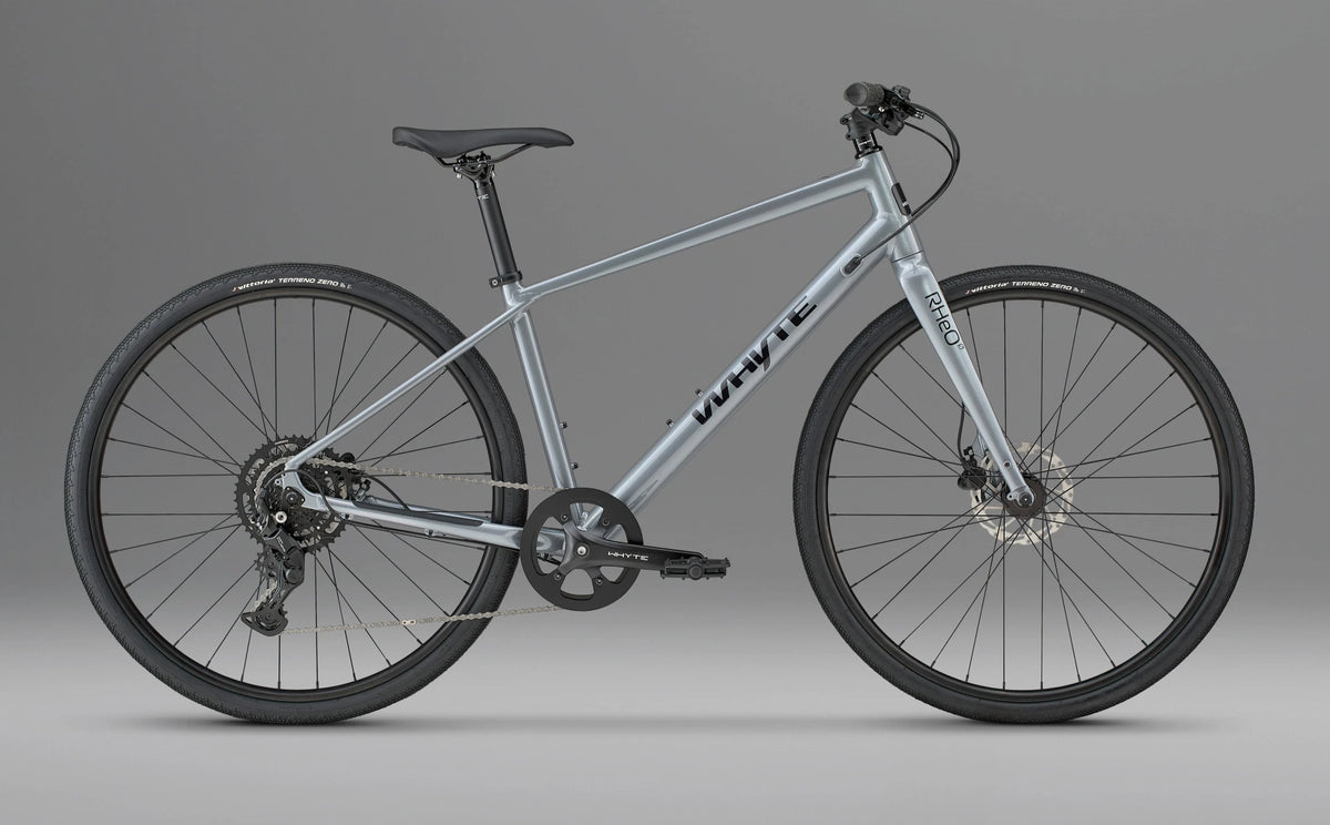 Whyte RHeO 0 hybrid bike in dark silver, drive-side profile on a grey background.
