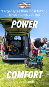 Man folding estarli E20.7 Comfort Hybrid E-Bike beside camper van, emphasizing power, comfort, and portability for outdoor adventures.